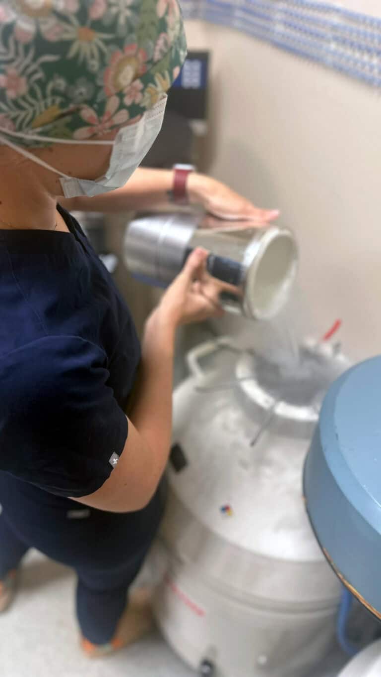 Embryologist Adding Liquid Nitrogen to Embryo Storage Tank at Nested Adoption Solutions