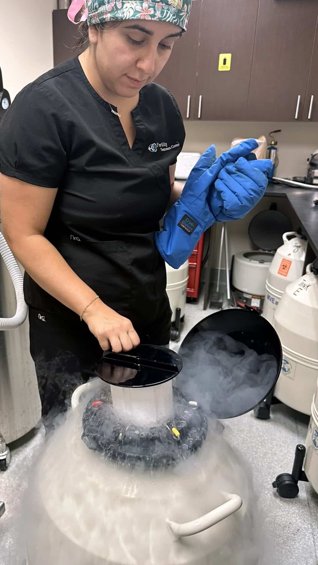 Senior Embryologist Examining Frozen Embryo Tank at Nested Adoption Solutions